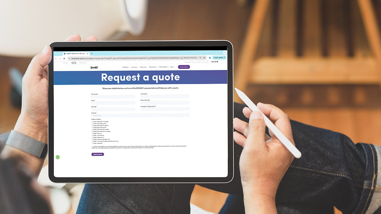 A person holding a tablet displaying the SMART 'Request a Quote' page, showcasing fields for submitting business/organization details.