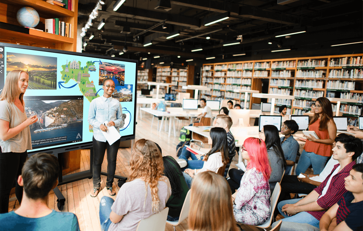 Teachers in a higher education setting with students using a T Pro series SMART Board